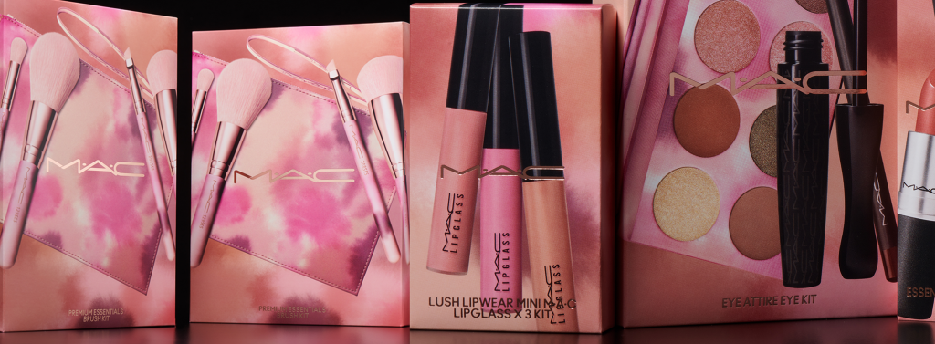 Lip gloss, eye shadow and mascara with peachy pink glossy packaging